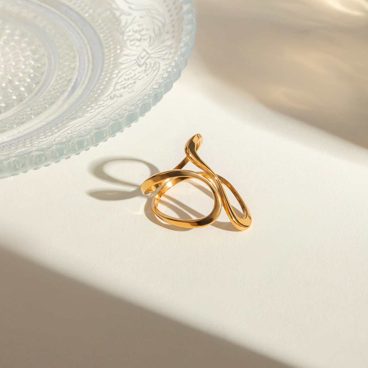 Gold ring on a white surface with a soft focus background