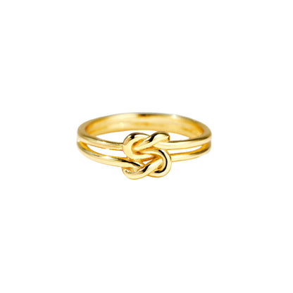 Gold knot ring on a white background