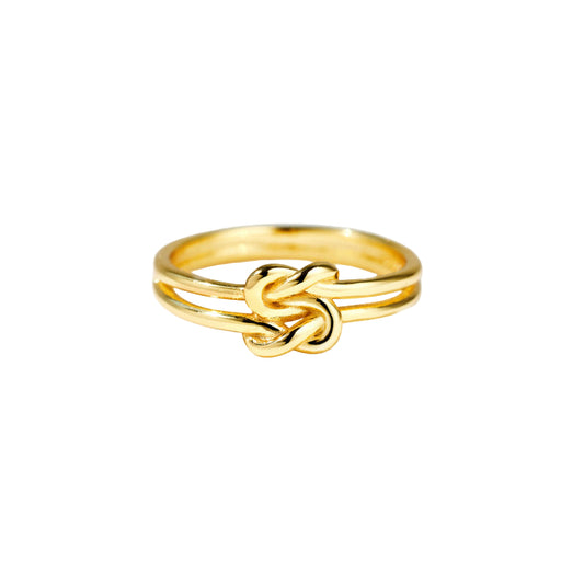 Gold knot ring on a white background