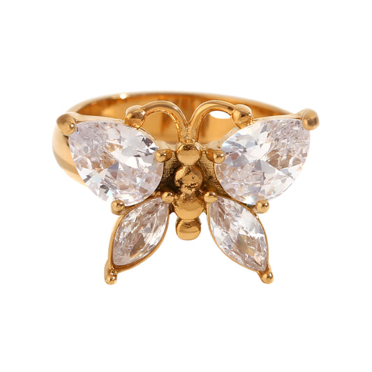 Gold butterfly ring with clear gemstones on a white background