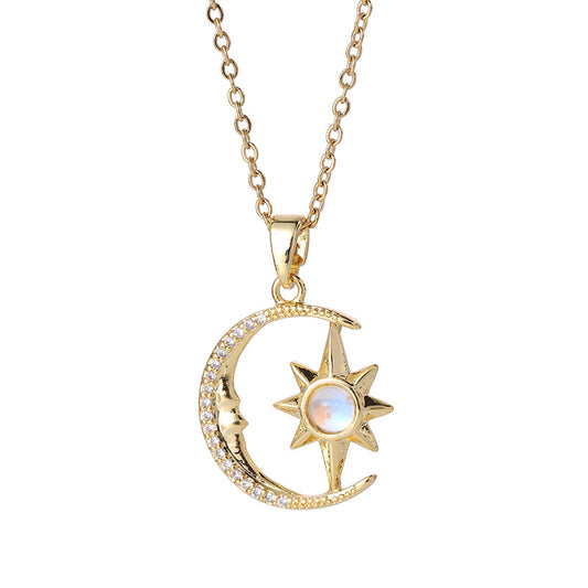 Gold necklace with moon and star pendant on a white background
