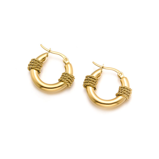Gold hoop earrings with braided design on a white background