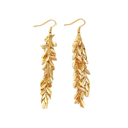 Gold leaf-shaped earrings on a white background
